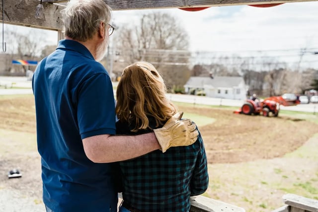 Couple overlooking their farm